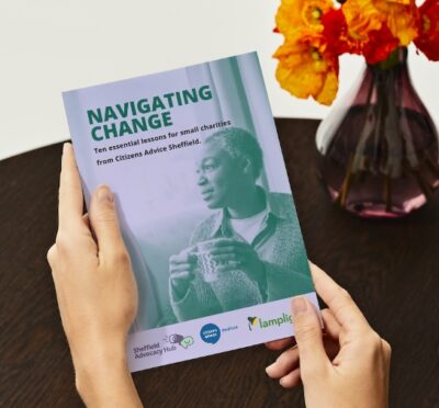 Image of 'Navigating Change' book in someone's hands