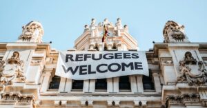 Building with a sign that says 'Refugees Welcome'