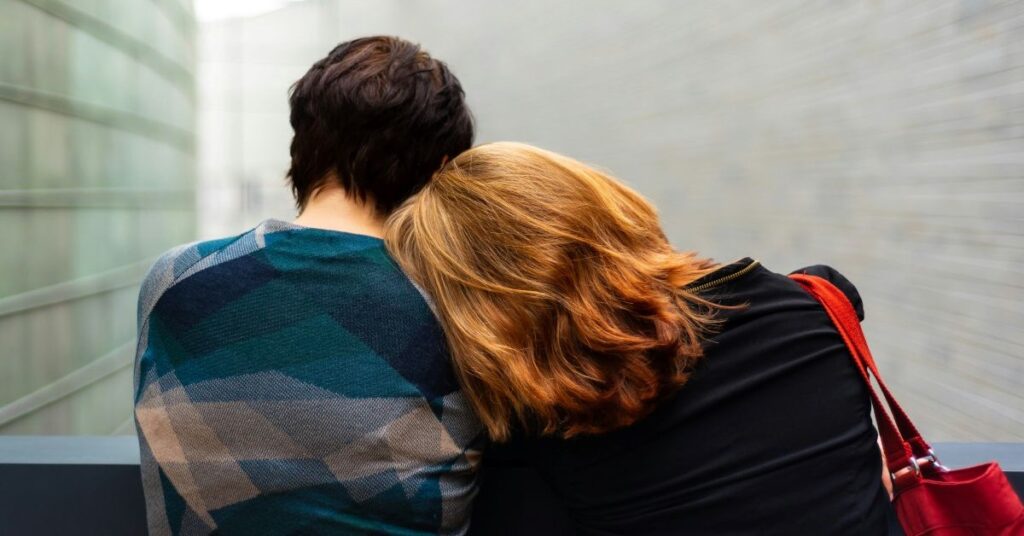 A person leaning on the shoulder of someone they trust and can confide in.